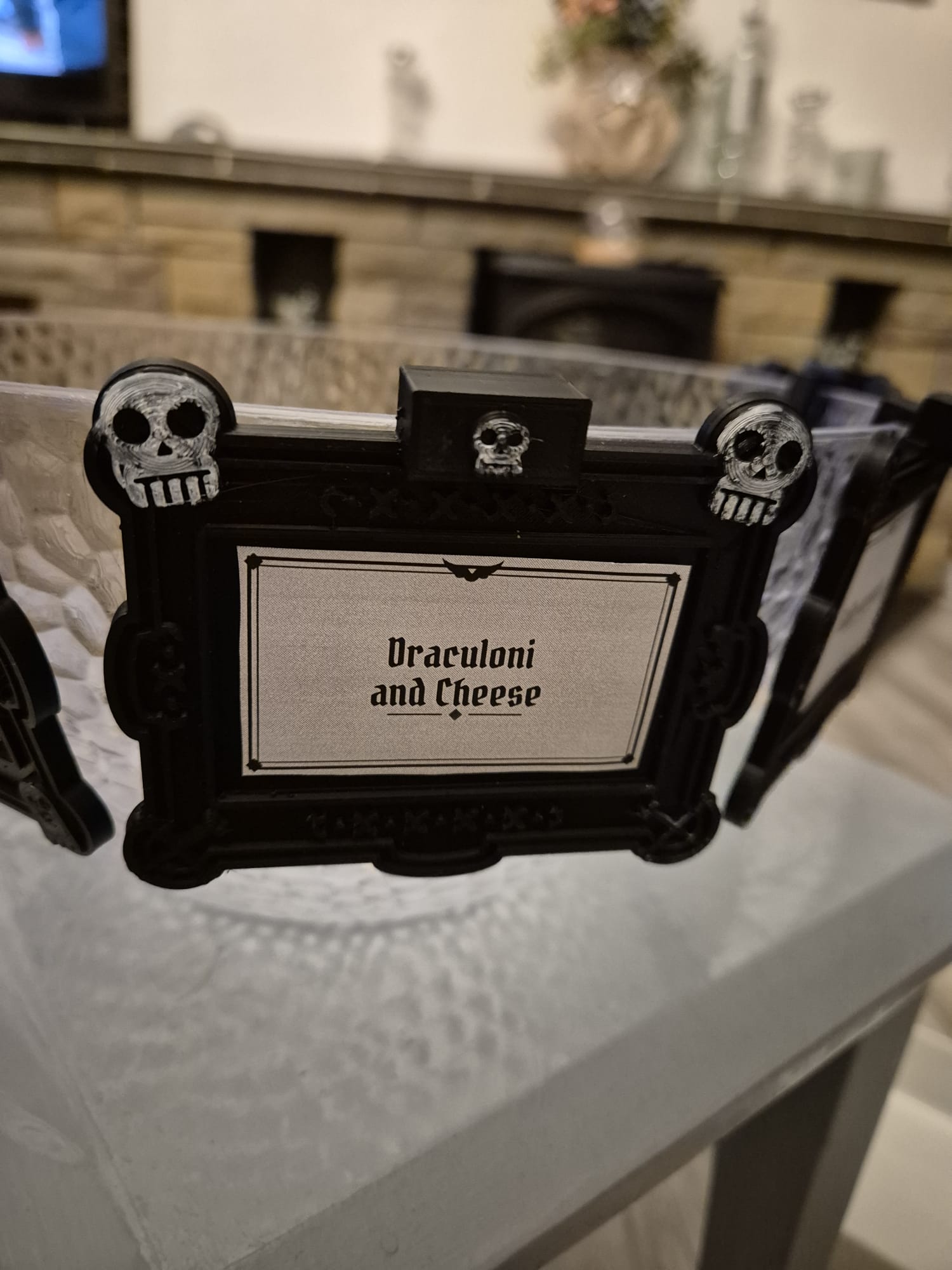 Skulls tag reading "Draculoni and Cheese" on a glass bowl