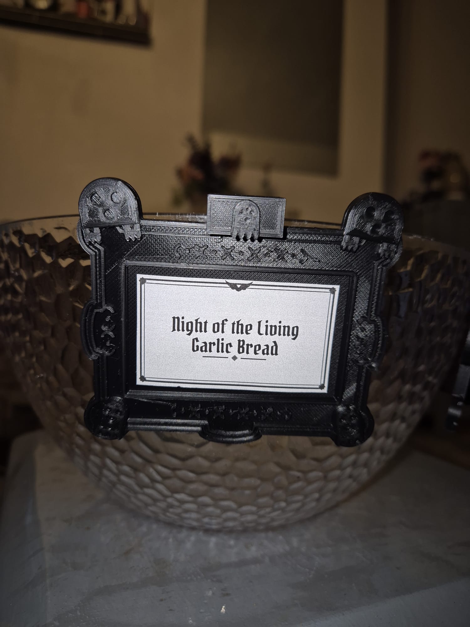Ghosts tag reading "Night of the Living Garlic Bread" on a glass bowl